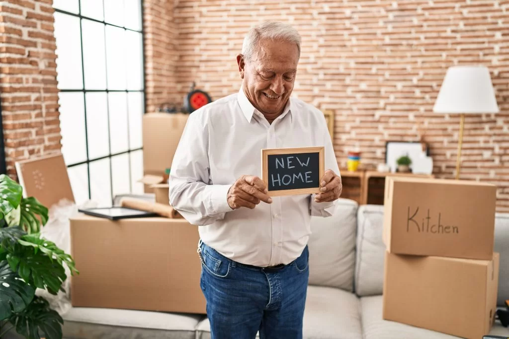 a man holding a sign in a room